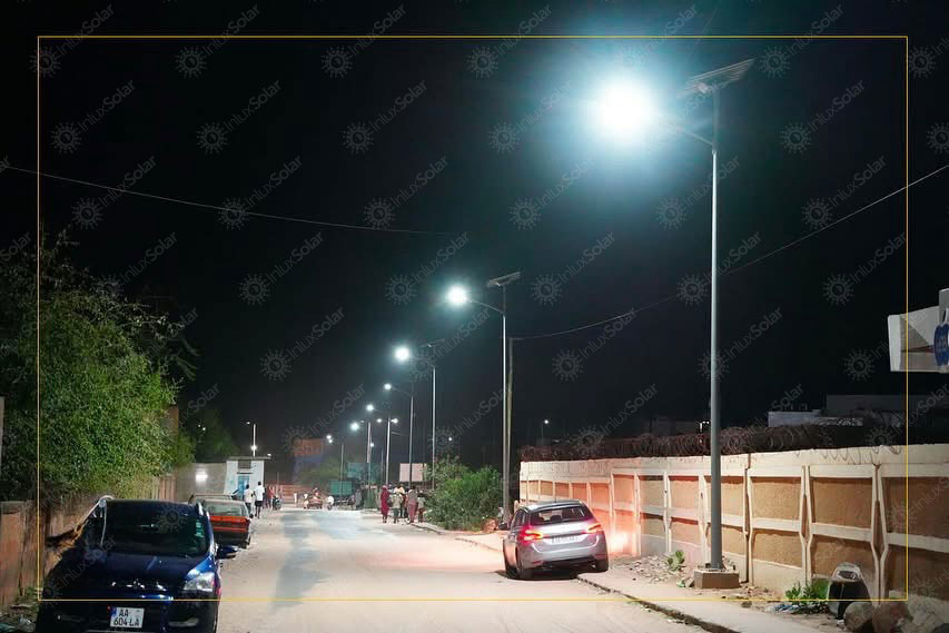 Residential road at night with solar street lights and roadside homes