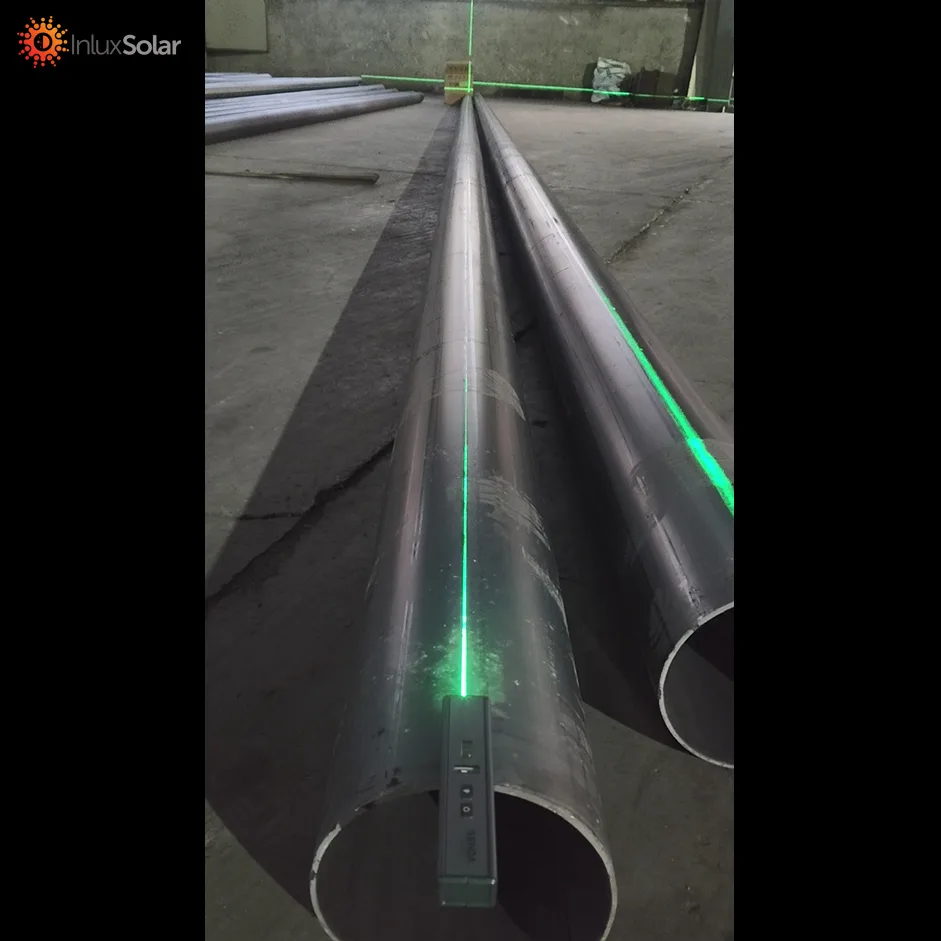 Technician performing laser verticality testing on a lighting pole at Inlux Solar factory