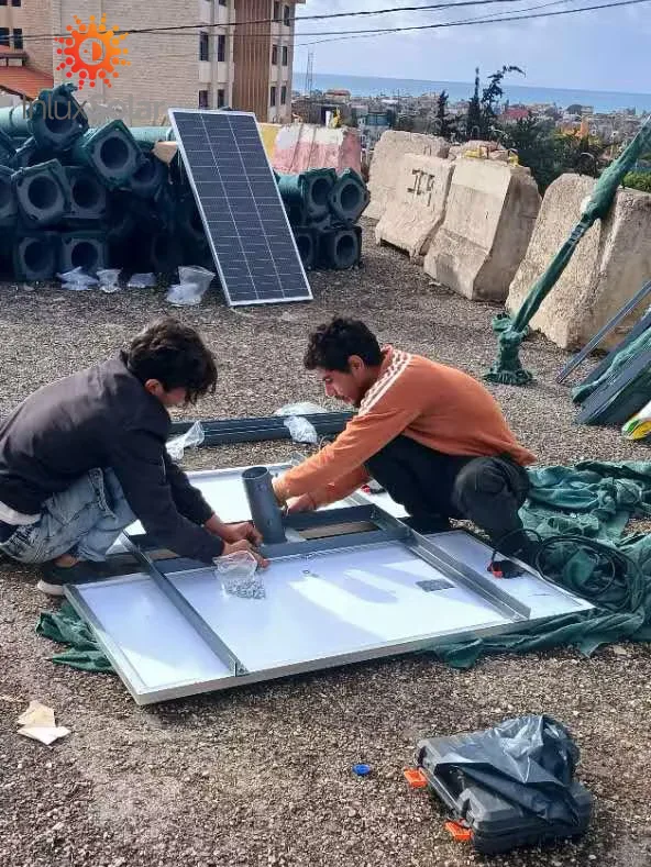 Installation team assembling solar street light components for Beirut project in Lebanon