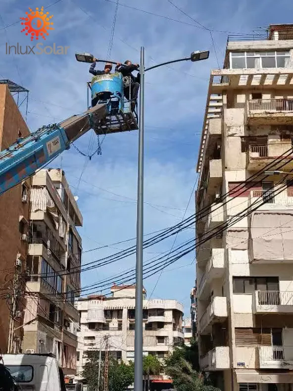 Double-arm street light installation using a bucket lift in Beirut, Lebanon
