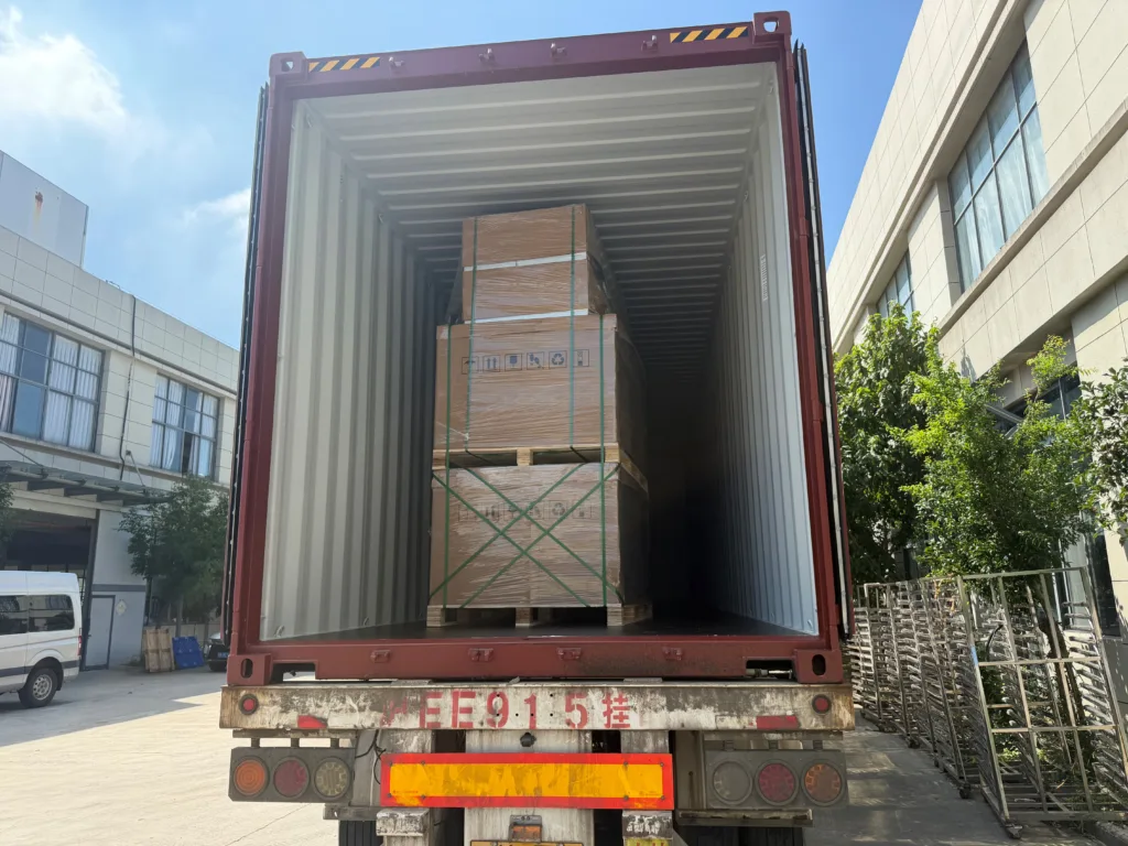 Crated Apollo solar modules secured inside a container before shipment to Chad.
