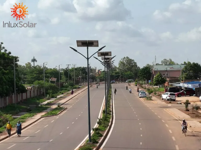 Dual-arm Apollo solar street lights along a divided municipal road in Ouagadougou