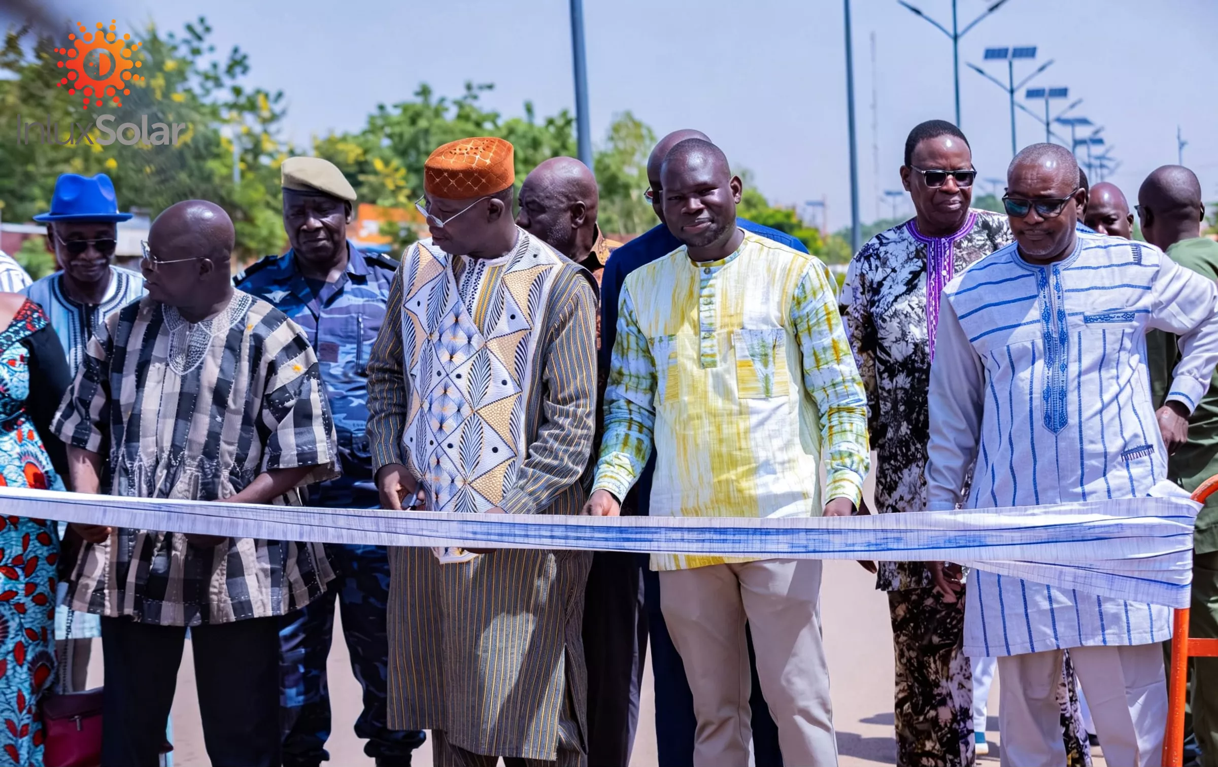 Municipal road opening event with central-median solar street lights in the background