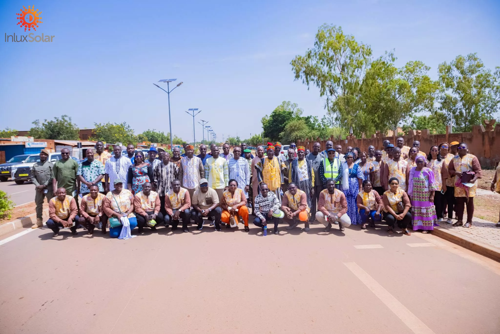 Project group on an Ouagadougou municipal road lined with dual-arm APOLLO solar street lights